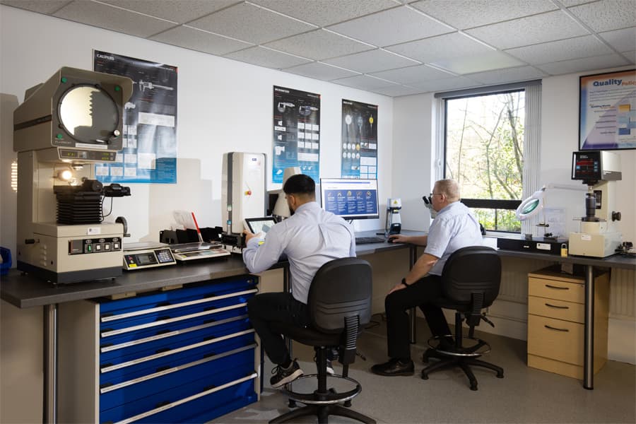 engineers sitting at desk performing quality inspections